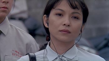 Movie still from “Eat Drink Man Woman” (1994), directed by Ang Lee – A woman wearing a white shirt and a white tie; Close Up shot, High angle