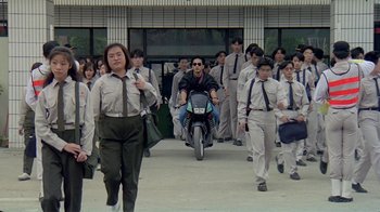 Movie still from “Eat Drink Man Woman” (1994), directed by Ang Lee – A group of people walking down a street; Wide shot, High angle
