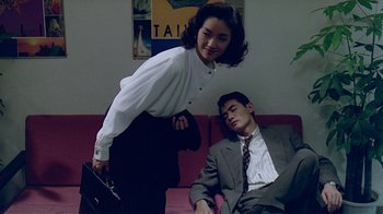 Movie still from “Eat Drink Man Woman” (1994), directed by Ang Lee – A man and a woman sitting on a red couch; Medium shot, High angle