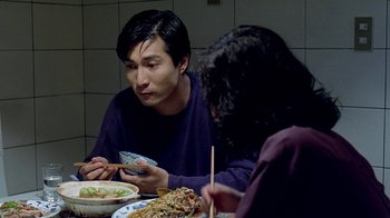 Movie still from “Eat Drink Man Woman” (1994), directed by Ang Lee – A man and a woman sitting at a dinner table; Close Up shot, High angle