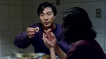 Movie still from “Eat Drink Man Woman” (1994), directed by Ang Lee – A man and a woman sitting at a dinner table; Close Up shot, Over the shoulder angle