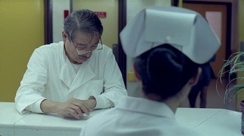 Movie still from “Eat Drink Man Woman” (1994), directed by Ang Lee – A man sitting at a table in front of another man; Close Up shot, Low angle