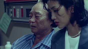 Movie still from “Eat Drink Man Woman” (1994), directed by Ang Lee – An older man and a younger woman are looking at each other; Close Up shot, Over the shoulder angle