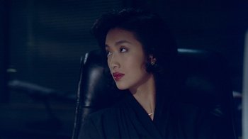 Movie still from “Eat Drink Man Woman” (1994), directed by Ang Lee – A woman sitting in a chair looking to her left; Close Up shot, Over the shoulder angle