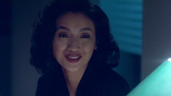Movie still from “Eat Drink Man Woman” (1994), directed by Ang Lee – A person smiling for the camera; Close Up shot, Over the shoulder angle