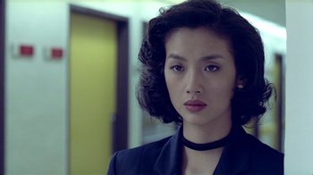 Movie still from “Eat Drink Man Woman” (1994), directed by Ang Lee – A woman in a black jacket and a black choker; Close Up shot, Over the shoulder angle