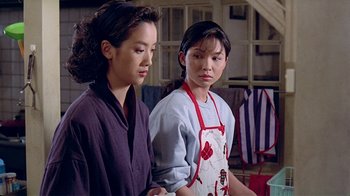 Movie still from “Eat Drink Man Woman” (1994), directed by Ang Lee – Two young women standing next to each other in a room; Medium shot, Low angle