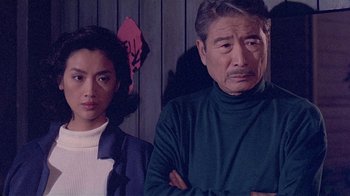 Movie still from “Eat Drink Man Woman” (1994), directed by Ang Lee – A man and a woman standing next to each other; Medium shot, Low angle