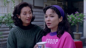 Movie still from “Eat Drink Man Woman” (1994), directed by Ang Lee – Two young women standing next to each other holding a cup; Close Up shot, Over the shoulder angle