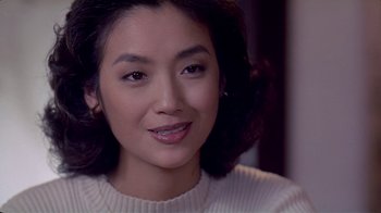 Movie still from “Eat Drink Man Woman” (1994), directed by Ang Lee – A person wearing a white sweater; Close Up shot, Over the shoulder angle