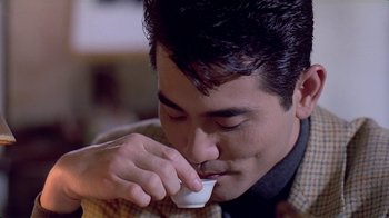 Movie still from “Eat Drink Man Woman” (1994), directed by Ang Lee – A person drinking a cup of coffee; Close Up shot, Over the shoulder angle