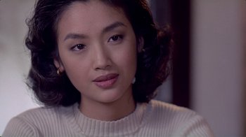 Movie still from “Eat Drink Man Woman” (1994), directed by Ang Lee – A person wearing a white sweater; Close Up shot, Over the shoulder angle