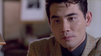 Movie still from “Eat Drink Man Woman” (1994), directed by Ang Lee – A person wearing a jacket; Close Up shot, Over the shoulder angle