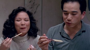 Movie still from “Eat Drink Man Woman” (1994), directed by Ang Lee – A man and a woman are holding chopsticks in their hands; Close Up shot, High angle