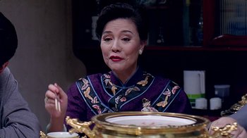 Movie still from “Eat Drink Man Woman” (1994), directed by Ang Lee – An older woman sitting in front of a plate of food; Close Up shot, Over the shoulder angle