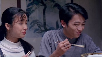 Movie still from “Eat Drink Man Woman” (1994), directed by Ang Lee – A man and a woman holding chopsticks in their hands; Close Up shot, Over the shoulder angle