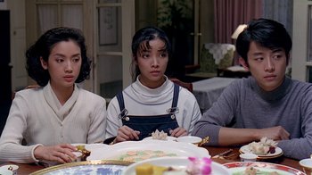 Movie still from “Eat Drink Man Woman” (1994), directed by Ang Lee – A group of people sitting around a table; Medium shot, High angle