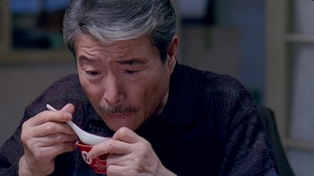Movie still from “Eat Drink Man Woman” (1994), directed by Ang Lee – An older man is holding a bowl of soup; Close Up shot, High angle