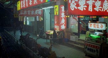 Movie still from “Rebels of the Neon God” (1992), directed by Tsai Ming-liang – People sitting at a table outside of a restaurant; Extreme Wide shot, High angle
