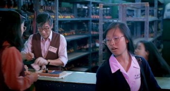 Movie still from “Rebels of the Neon God” (1992), directed by Tsai Ming-liang – A man and a woman working in a store; Medium shot, High angle