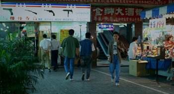 Movie still from “Rebels of the Neon God” (1992), directed by Tsai Ming-liang – A group of people walking down a street; Wide shot, High angle
