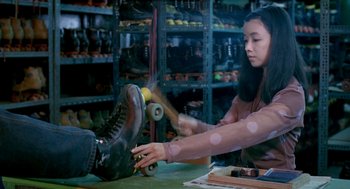Movie still from “Rebels of the Neon God” (1992), directed by Tsai Ming-liang – A woman is rolling a skateboard on a table; Medium shot, Low angle
