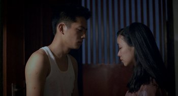 Movie still from “Rebels of the Neon God” (1992), directed by Tsai Ming-liang – A man and a woman face to face in the dark; Close Up shot, Over the shoulder angle