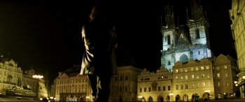 Movie still from “xXx” (2002), directed by Rob Cohen – A man walking in front of a building at night; Wide shot, Low angle
