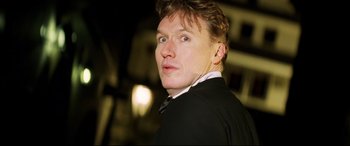 Movie still from “xXx” (2002), directed by Rob Cohen – A person wearing a suit and tie; Close Up shot, Low angle