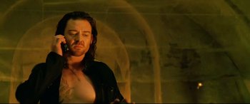 Movie still from “xXx” (2002), directed by Rob Cohen – A man with long brown hair and a black shirt; Medium shot, Low angle