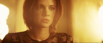 Movie still from “xXx” (2002), directed by Rob Cohen – A woman with long brown hair wearing a black shirt; Close Up shot, Low angle