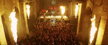 Movie still from “xXx” (2002), directed by Rob Cohen – A crowd of people in front of a stage; Extreme Wide shot, High angle