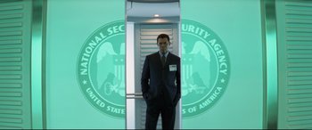 Movie still from “xXx” (2002), directed by Rob Cohen – A man standing in front of an nsa logo; Medium shot, Low angle
