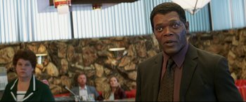 Movie still from “xXx” (2002), directed by Rob Cohen – A man standing in front of two other people; Close Up shot, Over the shoulder angle