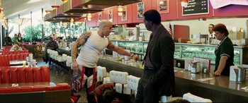 Movie still from “xXx” (2002), directed by Rob Cohen – Two men are fighting in a restaurant; Medium shot, Over the shoulder angle