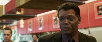 Movie still from “xXx” (2002), directed by Rob Cohen – A person wearing a suit and tie; Close Up shot, Over the shoulder angle