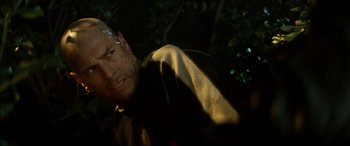 Movie still from “xXx” (2002), directed by Rob Cohen – A man with a beard is looking at the camera; Close Up shot, Over the shoulder angle