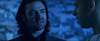 Movie still from “xXx” (2002), directed by Rob Cohen – A person with long black hair; Close Up shot, Low angle