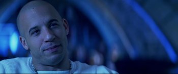 Movie still from “xXx” (2002), directed by Rob Cohen – A person smiling; Close Up shot, Over the shoulder angle