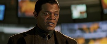 Movie still from “xXx” (2002), directed by Rob Cohen – A person wearing a suit and tie; Close Up shot, Low angle