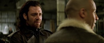 Movie still from “xXx” (2002), directed by Rob Cohen – A person wearing a leather jacket; Close Up shot, Over the shoulder angle