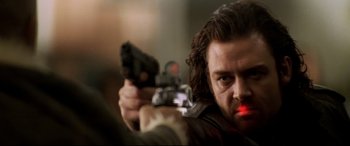 Movie still from “xXx” (2002), directed by Rob Cohen – A person holding a gun; Close Up shot, Low angle