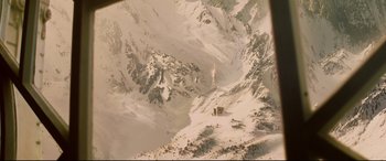 Movie still from “xXx” (2002), directed by Rob Cohen – A snowy mountain with a tower in the distance; Extreme Wide shot, High angle