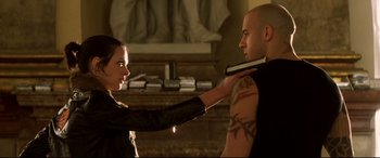 Movie still from “xXx” (2002), directed by Rob Cohen – A man and a woman are holding something in their hands; Close Up shot, Low angle