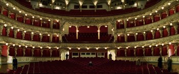 Movie still from “xXx” (2002), directed by Rob Cohen – Two people are standing in a large theater; Extreme Wide shot, High angle