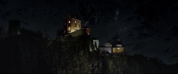 Movie still from “xXx” (2002), directed by Rob Cohen – A night view of a castle on top of a hill; Extreme Wide shot, Low angle