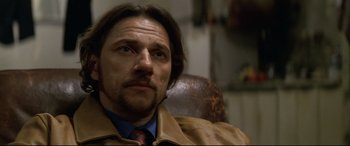 Movie still from “xXx” (2002), directed by Rob Cohen – A person wearing a suit and tie; Close Up shot, Low angle