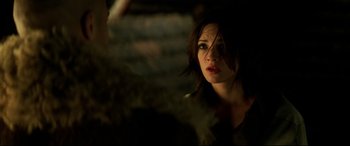 Movie still from “xXx” (2002), directed by Rob Cohen – A beautiful woman with dark hair and red lipstick; Close Up shot, Over the shoulder angle