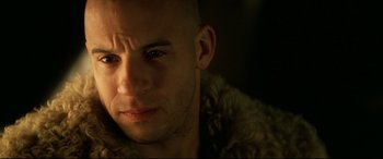 Movie still from “xXx” (2002), directed by Rob Cohen – A man with a shaved head wearing a fur coat; Close Up shot, Over the shoulder angle