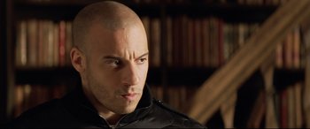 Movie still from “xXx” (2002), directed by Rob Cohen – A man with a bald head looking at the camera; Close Up shot, Low angle